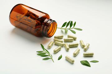 Sticker - Bottle, vitamin capsules and leaves on white background