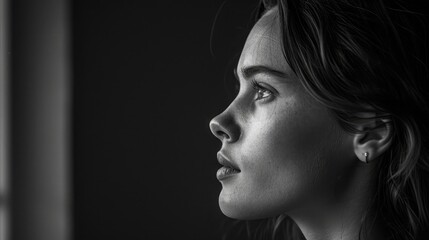 Wall Mural - Portrait of young woman in profile close up, Black and white, Low key