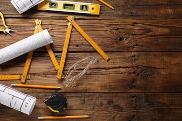 Poster - Flat lay composition with building level and other construction tools on wooden table, space for text