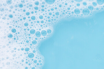 Wall Mural - Detergent foam bubble on water. Blue background, Soap sud