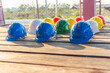© aFotostock - Construction hard hat safety tools equipment for workers in construction site for engineering protection head standard. Many hard hat helmet on row with copy space. Engineering Construction Concept