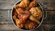 A bucket filled with an assortment of crispy fried chicken parts, promising a flavorful feast for anyone who indulges