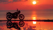 Silhouette of motorcycle against sunset near coastline