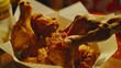 Close-up of a hand reaching into a paper bucket, fingers poised to grasp a piece of perfectly fried chicken