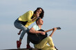 © Volodymyr - Excited sexy couple enjoy music with microphones and guitar. Sexy couple singing outdoor. Love music. Couple in love singing and playing guitar. Music and Musical instrument concept. Outdoor music.