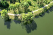 curving footpath on riverbank. summer green park landscape with river. aerial drone view.