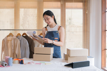 Poster - Woman checking her merchandise in cloth shop