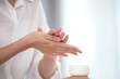 Close up, young woman's beautiful hands are applying hand cream to moisturize her hands, healthy skin, skin care concept