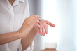 Close up, young woman's beautiful hands are applying hand cream to moisturize her hands, healthy skin, skin care concept