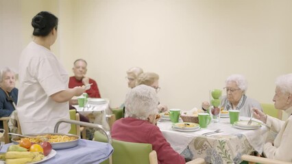 Wall Mural - Cook serving food to seniors in a geriatric