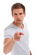 Pointing, serious and portrait of man on a white background for problem, strict and conflict. Anger, fight and isolated person with hand sign, finger and gesture in studio with frustrated reaction