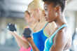 Black woman, dumbbell and serious for workout in gym for fitness, class and muscle growth. Female person, weight and concentrated for exercise in center for training, sport and strength development