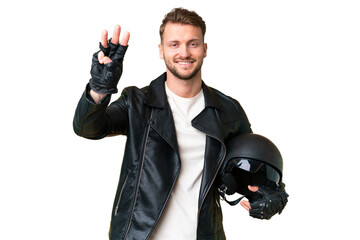 Wall Mural - Young caucasian man with a motorcycle helmet over isolated chroma key background happy and counting three with fingers