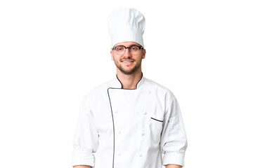 Wall Mural - Young caucasian chef over isolated chroma key background with glasses and happy