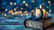 Illuminated candle on an old ornate book with sparkling bokeh lights in the backdrop