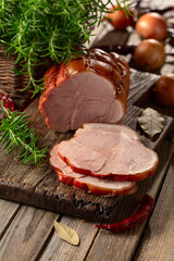 Wall Mural - Smoked pork ham on a wooden table.