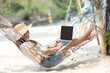 Lifestyle freelance woman using laptop working and relax on the beach.  Asian people success and together your work pastime and meeting conference on internet in holiday. Business and Summer Concept