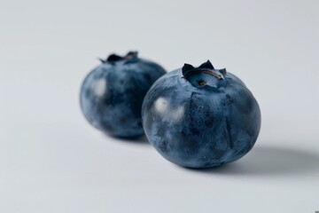 Wall Mural - pair of blueberries close-up, minimalist design isolated on a white background 