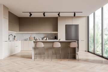 Stylish hotel kitchen interior with bar counter and chairs near panoramic window