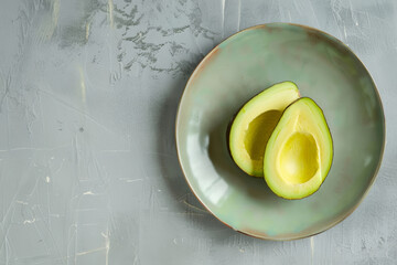 Wall Mural - sliced avocado on a bright ceramic plate, minimalist style, top view with copy space 