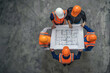 © Degimages - Top view, construction workers and blueprint planning in house, home or office building in real estate.