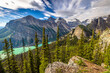 Stunning panoramic view of Lake Louise surrounded by rugged snow-capped mountains including Big Beehive from Little Beehive, Banff National Park, Alberta, Canada.