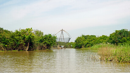 Wall Mural - fisherman boat on the tonle sap river in cambodia