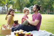 Happy family picnic in the park public on summer holiday.  Family relax and enjoying outdoor.  Family and Lifestyle Concept