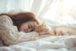 Young woman tenderly hugs her cat tightly lying in a light bed. Friendship concept between humans and animals