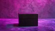 Behold a midnight black box, its surface kissed by a gentle sheen, standing boldly against a backdrop of royal purple