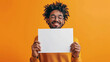 © Aimages - Man is holding up a blank whiteboard on isolated orange color background, vibrant, eye- catching, playfulness and fun