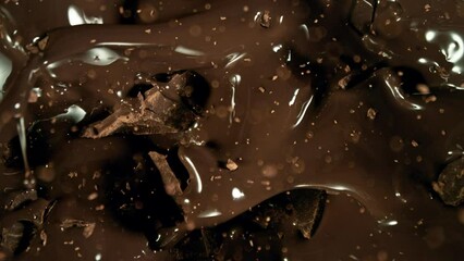 Poster - Super Slow Motion of Falling Group of Chocolate Chunks. Moving Down and Splashing into Melted Chocolate. Filmed on High Speed Cinema Camera, 1000fps.