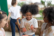 African American little girls and friends have fun hands painted in colorful paint.education concept
