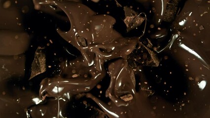 Poster - Super Slow Motion of Falling Group of Chocolate Chunks. Moving Down and Splashing into Melted Chocolate. Filmed on High Speed Cinema Camera, 1000fps.