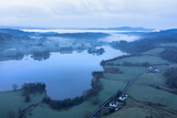 Fototapeta Londyn - Stunning drone aerial landscape image of cloud inversion around Esthwaite Water in Lake District during Spring sunrise