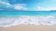 Beautiful sandy beach with gentle rolling sea waves accompanied by views of blue sky and white clouds