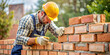 © Mr. Washington - bricklayer working scaffold yellow protective helmet brick trowel builder building wall