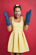 © peopleimages.com - Cooking, problem and portrait of woman with surprise on date with gloves for oven in studio background. Kitchen, accident or girl frustrated with grill mistake or barbecue fail on mockup space