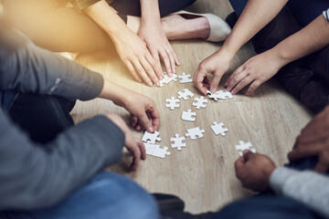 Canvas Print - People, training and hands with puzzle on table for problem solving, learning and integration of strategy. Diversity, team and support with jigsaw for creative teamwork, interaction and collaboration