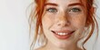 close up of a smiling face of a young redhead girl with freckles smiling
