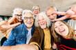 © Xavier Lorenzo - Joyful portrait of senior group of retired people enjoying time together taking selfie photo with phone. Elderly community people having fun during vacation.