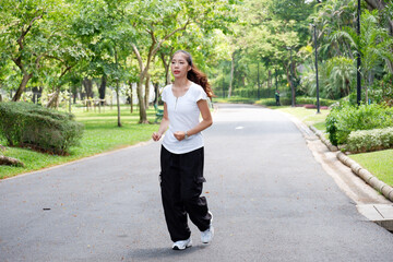 Young woman jogging in the park Exercise for health.