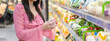 Portrait of beauty asian happy woman relax and enjoy shopping time with trolley cart buy healthy food package of grocery food with clean vegan eating vegetable and fruit at shopping supermarket