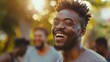 © Molang Visual - Portrait of a joyful African-American man laughing outdoors