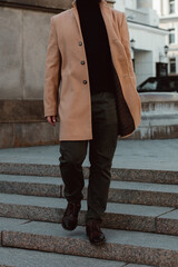 Poster - Stylish details of brown beige men's coat, pants and black turtleneck. Classic street outerwear