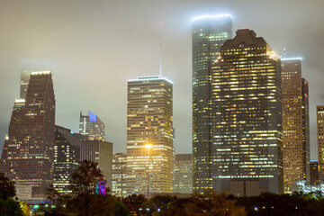 Wall Mural - Houston Texas downtown city skyline illuminated buildings. Photo taken on a cloudy foggy evening