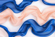 Matte royal blue and pale peach tiddle waves on a solid white background, combining regal elegance with soft warmth.