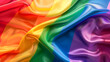 A silken rainbow flag waving with a vibrant display of color, symbolizing LGBTQ+ pride and diversity.