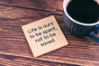 Inspirational quotes Life is ours to be spent, not to be saved text on adhesive note and cup of coffee