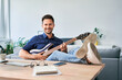 Man with electric guitar relaxed at home